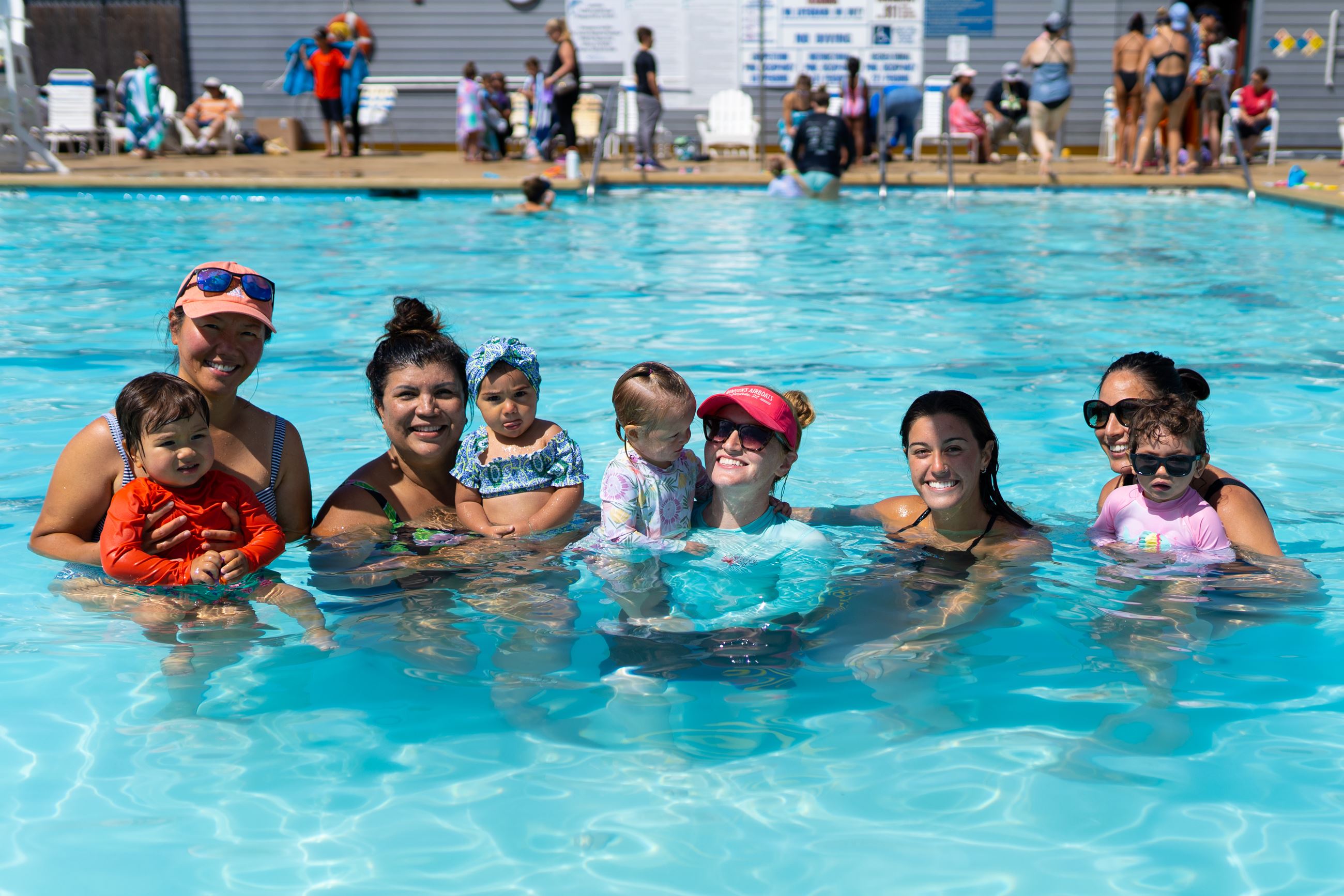 Group of parents and children in a pool for swim lessons
